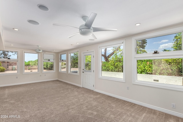 unfurnished sunroom featuring plenty of natural light and ceiling fan