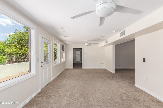 spare room with light carpet and ceiling fan