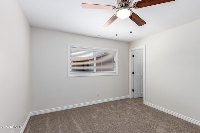 carpeted empty room featuring ceiling fan