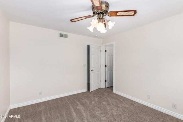 spare room with ceiling fan and carpet