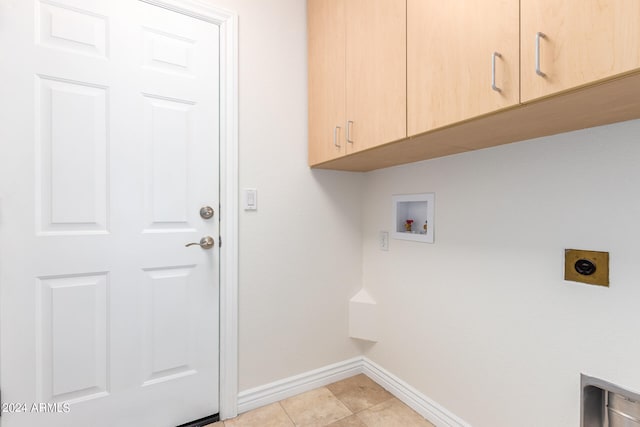 washroom with cabinets, washer hookup, hookup for an electric dryer, and light tile patterned flooring