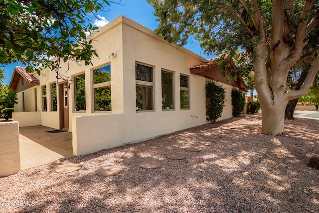 view of side of property featuring a patio area