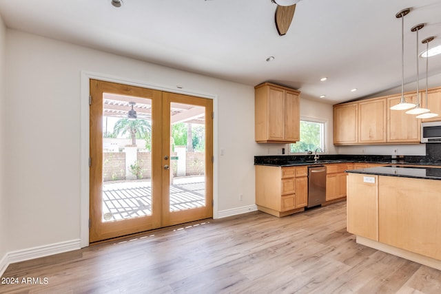 kitchen with light wood-type flooring, stainless steel appliances, decorative light fixtures, and light brown cabinets