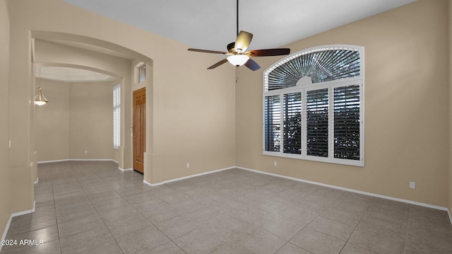 unfurnished room with ceiling fan and light tile patterned flooring