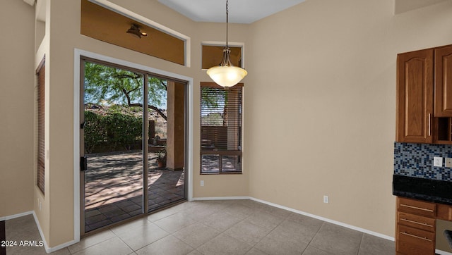 unfurnished dining area with light tile patterned floors