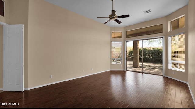 empty room with dark hardwood / wood-style floors and ceiling fan