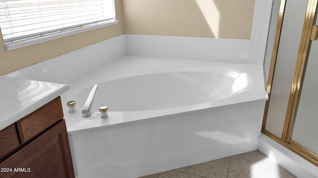 bathroom featuring vanity, tile patterned floors, and shower with separate bathtub