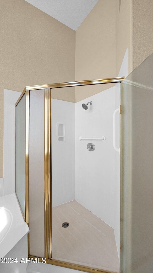 bathroom with vanity and a shower with shower door