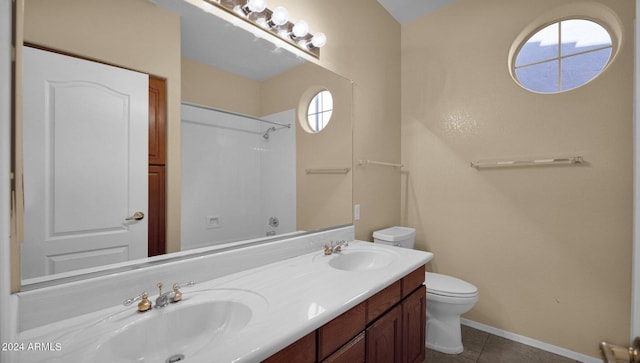 bathroom featuring vanity, tile patterned floors, and toilet