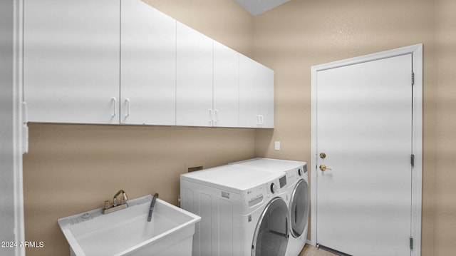 laundry area with cabinets, sink, and washing machine and clothes dryer