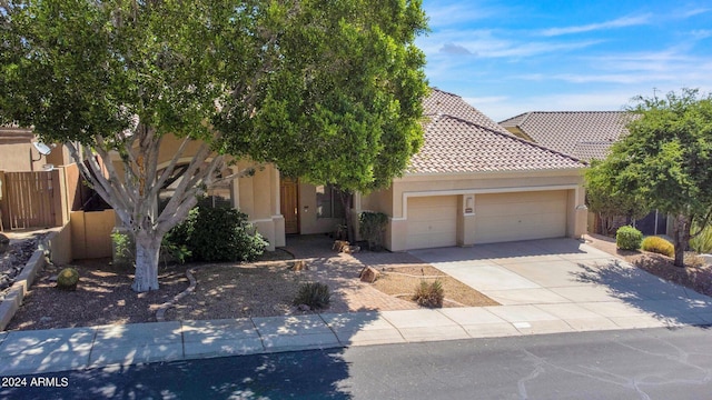 view of property hidden behind natural elements featuring a garage