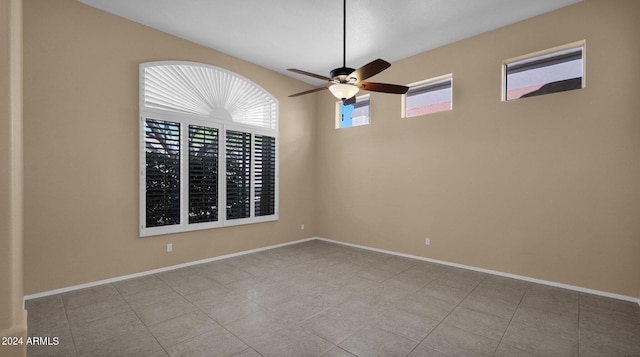 spare room featuring ceiling fan and light tile patterned flooring