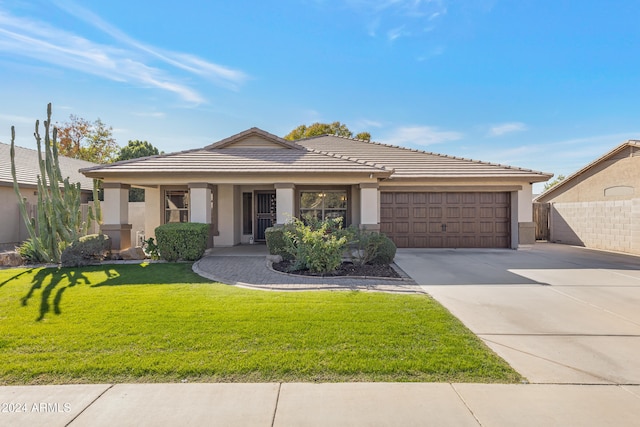 view of front of property with a front lawn and a garage