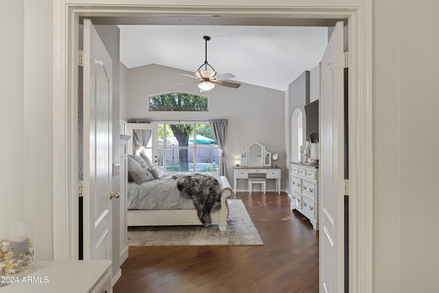 bedroom featuring dark hardwood / wood-style flooring, vaulted ceiling, and ceiling fan