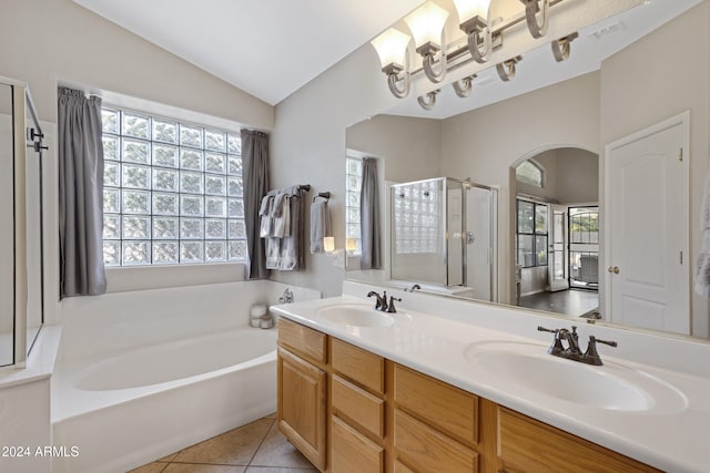 bathroom with separate shower and tub, tile patterned flooring, vanity, and vaulted ceiling