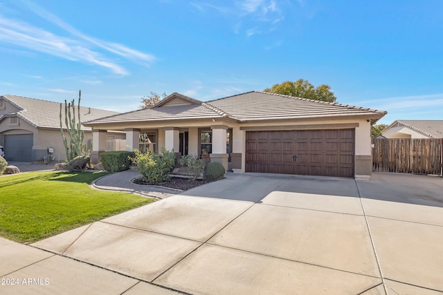 view of front of house featuring a front yard and a garage