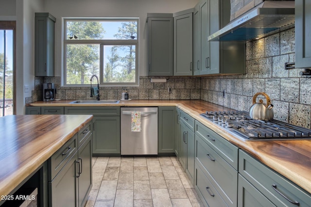 1014 Etta Ln, Show Low, AZ 85901 - kitchen with butcher block counters, stainless steel appliances, a sink, range hood, and backsplash