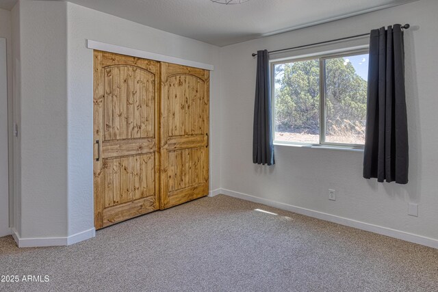 1014 Etta Ln, Show Low, AZ 85901 - unfurnished bedroom with light colored carpet and baseboards