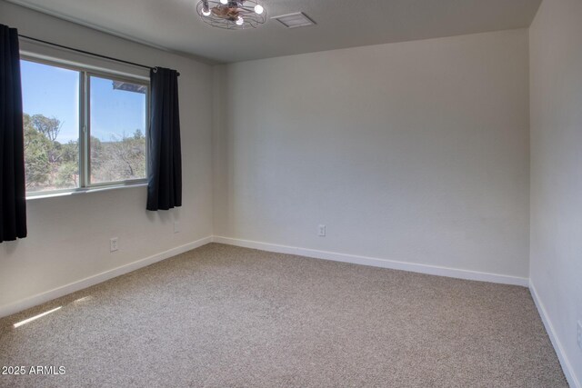 1014 Etta Ln, Show Low, AZ 85901 - carpeted empty room with baseboards and a chandelier