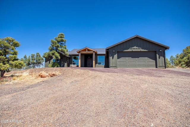 1014 Etta Ln, Show Low, AZ 85901 - view of front of property featuring board and batten siding, driveway, a garage, and metal roof