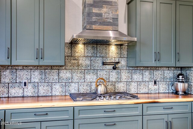 1014 Etta Ln, Show Low, AZ 85901 - kitchen featuring wall chimney range hood, decorative backsplash, butcher block countertops, and stainless steel gas cooktop