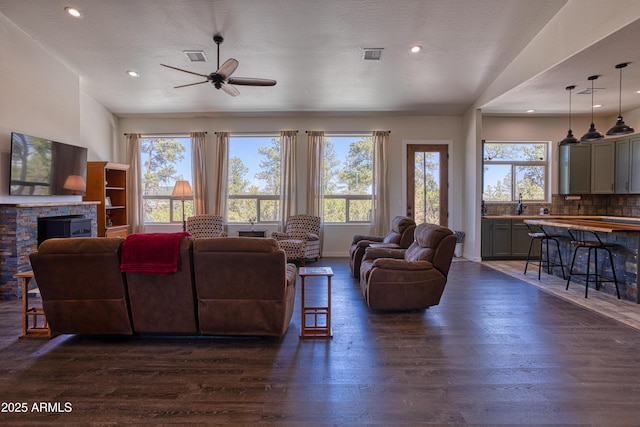 1014 Etta Ln, Show Low, AZ 85901 - living area featuring healthy amount of natural light, ceiling fan, dark wood finished floors, a fireplace, and recessed lighting
