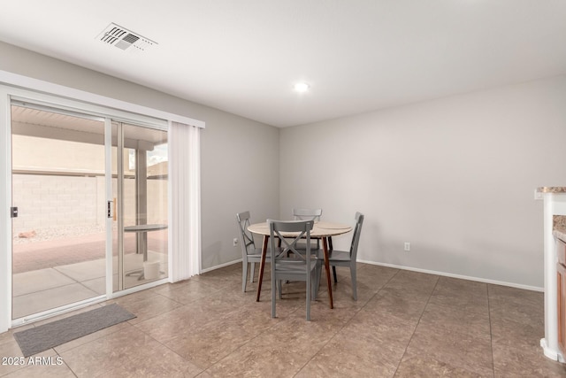 dining room featuring baseboards and visible vents