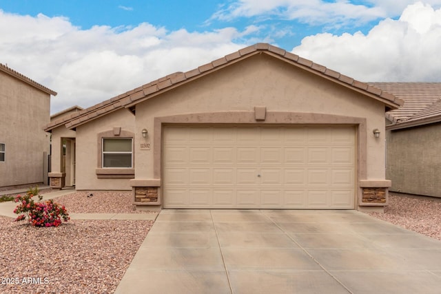 ranch-style home with a tile roof, an attached garage, driveway, and stucco siding