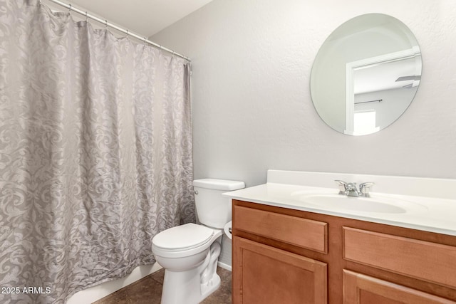 full bath with tile patterned floors, curtained shower, toilet, and vanity