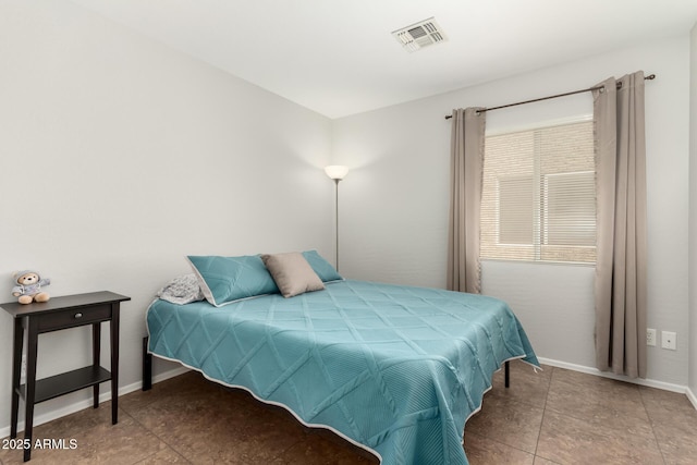 bedroom with baseboards and visible vents