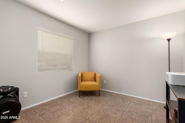 living area with tile patterned floors and baseboards