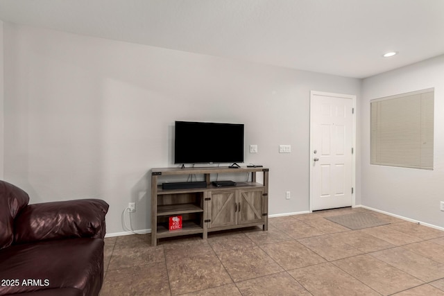 living area with tile patterned flooring, recessed lighting, and baseboards