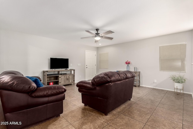 tiled living area featuring baseboards and a ceiling fan