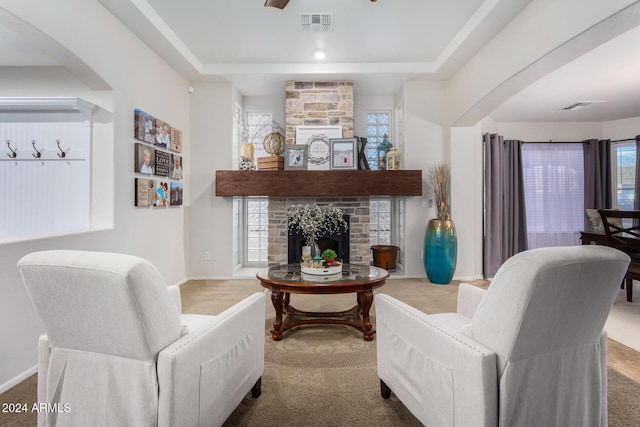 carpeted living room with a fireplace and plenty of natural light