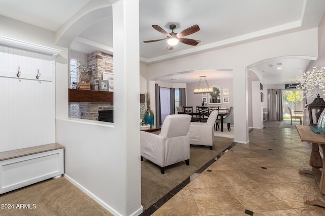 living room featuring ceiling fan and tile patterned flooring