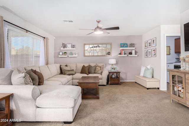 carpeted living room with ceiling fan