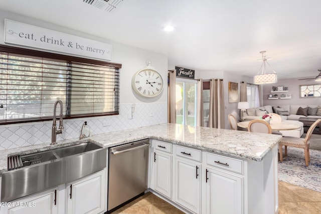 kitchen featuring dishwasher, kitchen peninsula, white cabinetry, and plenty of natural light