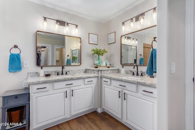 bathroom featuring walk in shower, vanity, and hardwood / wood-style flooring