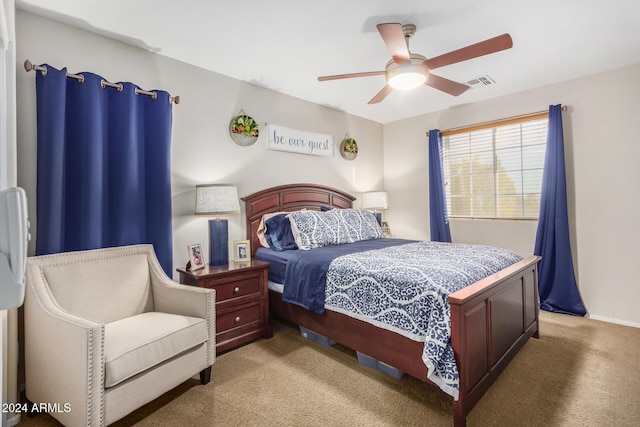 bedroom featuring ceiling fan and light carpet