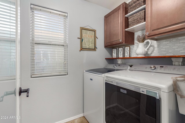 laundry room featuring cabinets and separate washer and dryer