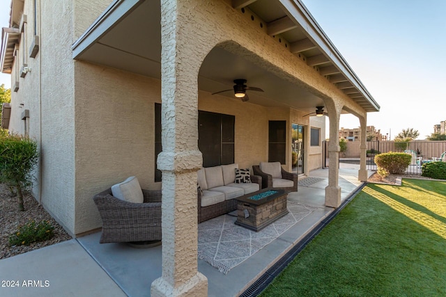 view of patio with ceiling fan and an outdoor fire pit