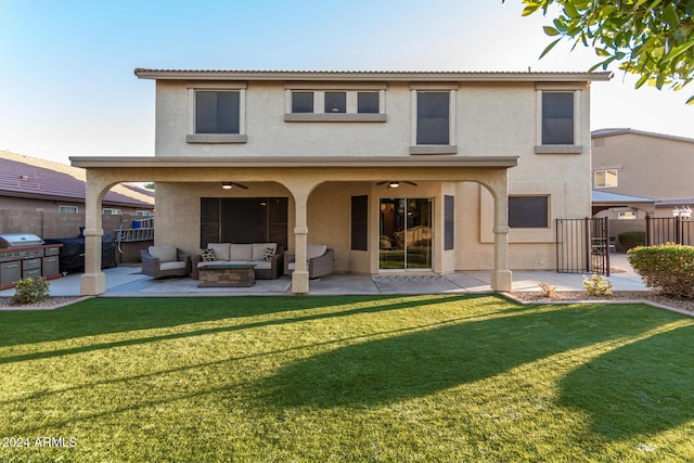 rear view of house featuring outdoor lounge area, a yard, ceiling fan, and a patio area