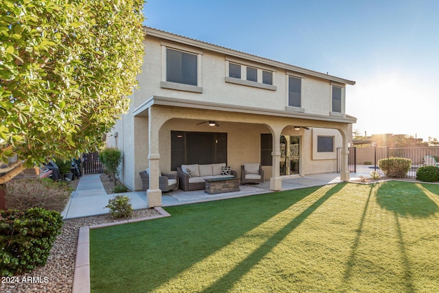 rear view of property featuring a lawn, outdoor lounge area, a patio area, and ceiling fan