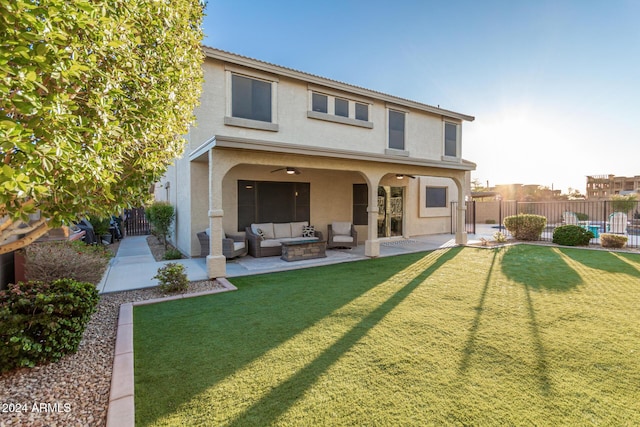 rear view of house featuring a lawn, an outdoor living space, ceiling fan, and a patio area