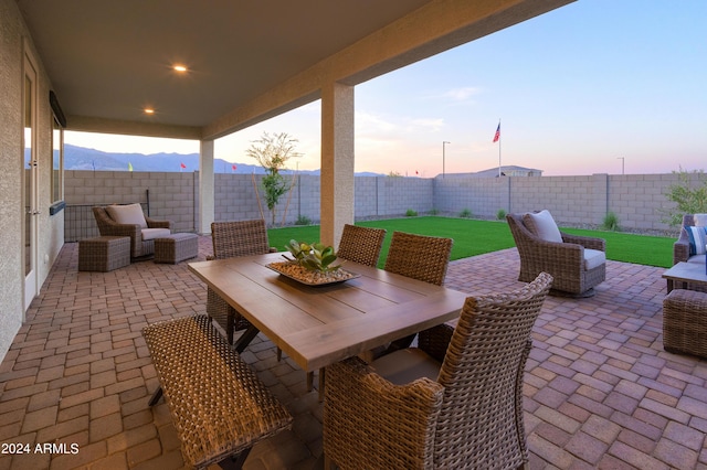 patio terrace at dusk featuring outdoor lounge area