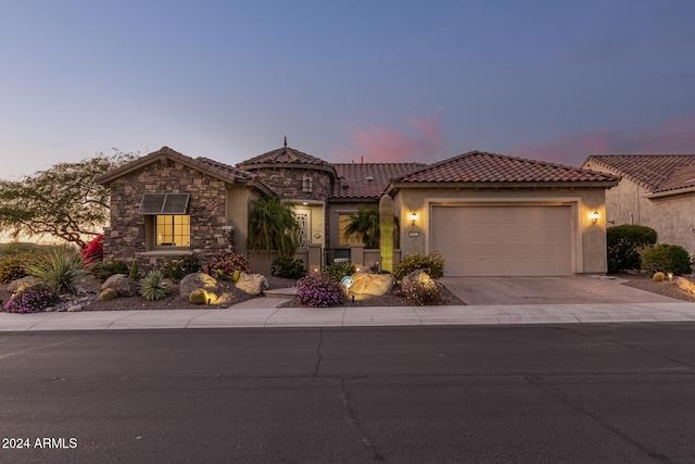 mediterranean / spanish home with a garage