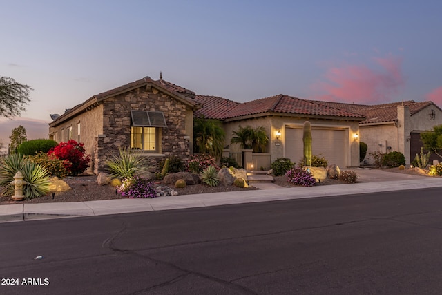 mediterranean / spanish house with a garage