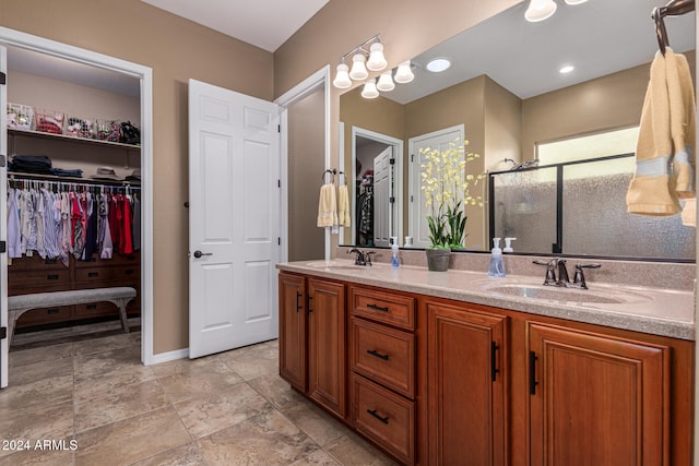 bathroom with vanity and a shower with shower door