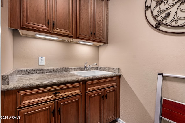 clothes washing area featuring sink