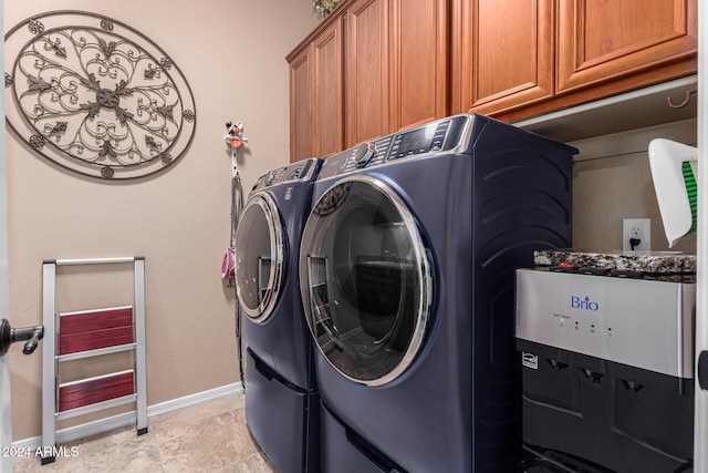 washroom featuring separate washer and dryer, light tile patterned flooring, and cabinets